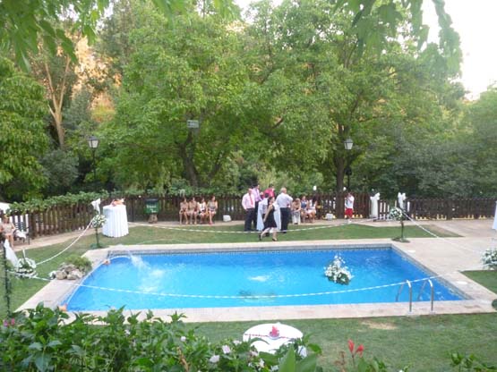 Los invitados a una boda toman un aperitivo alrededor de la piscina del Huertecillo